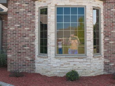 Flashing neighbor with camera through window.